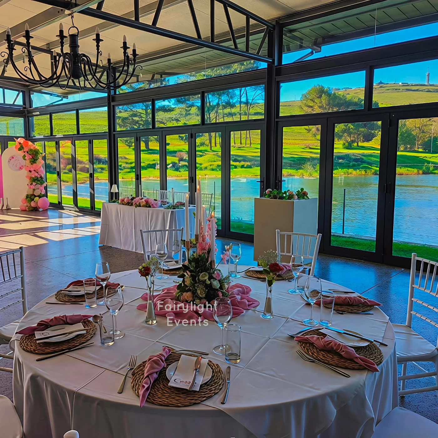 Elegant 60th birthday table setting overlooking the water by Fairylight Events